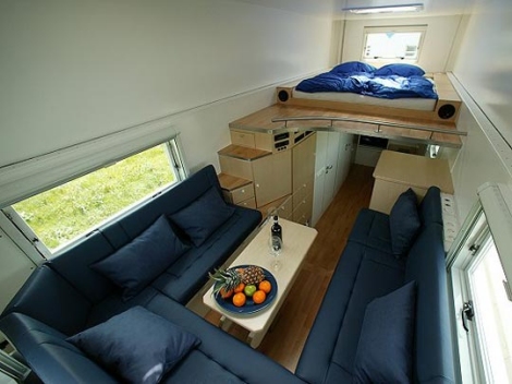 The sleeping loft, built-in sectional and the kitchen and home office